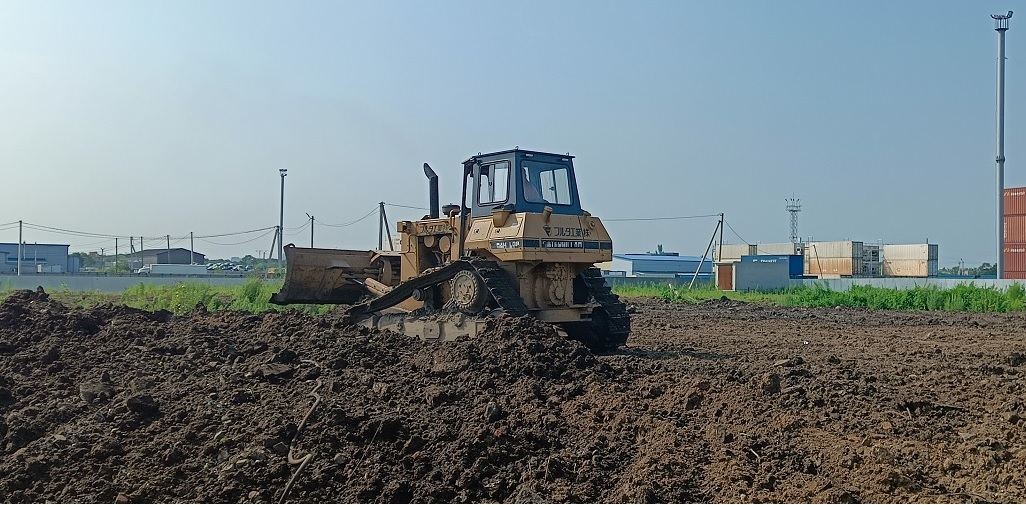 Бульдозер и экскватор роют и копают котлованы в Попасной